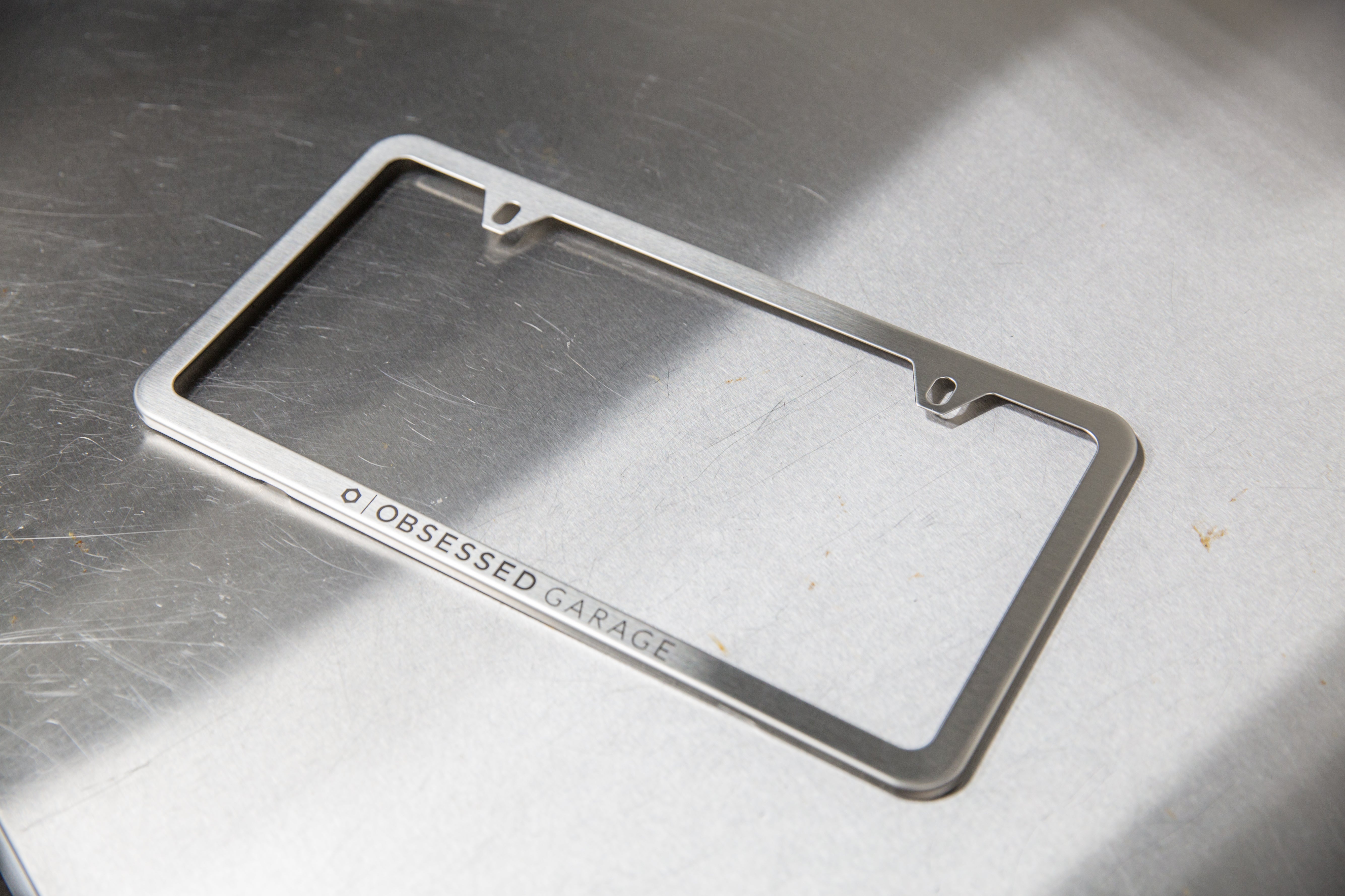 Premium Slim Plate Frames in Brushed Stainless Steel and Black