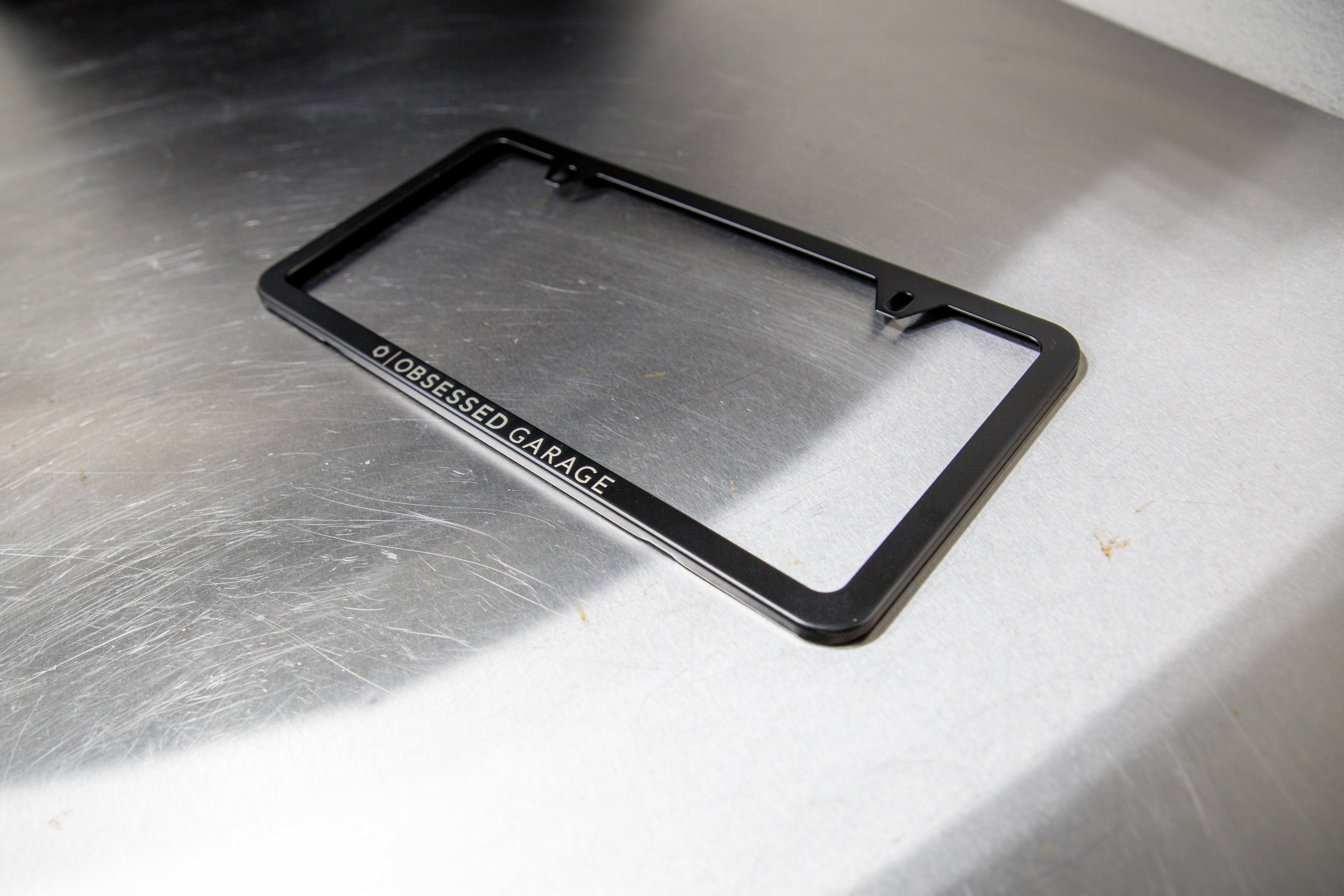 Premium Slim Plate Frames in Brushed Stainless Steel and Black